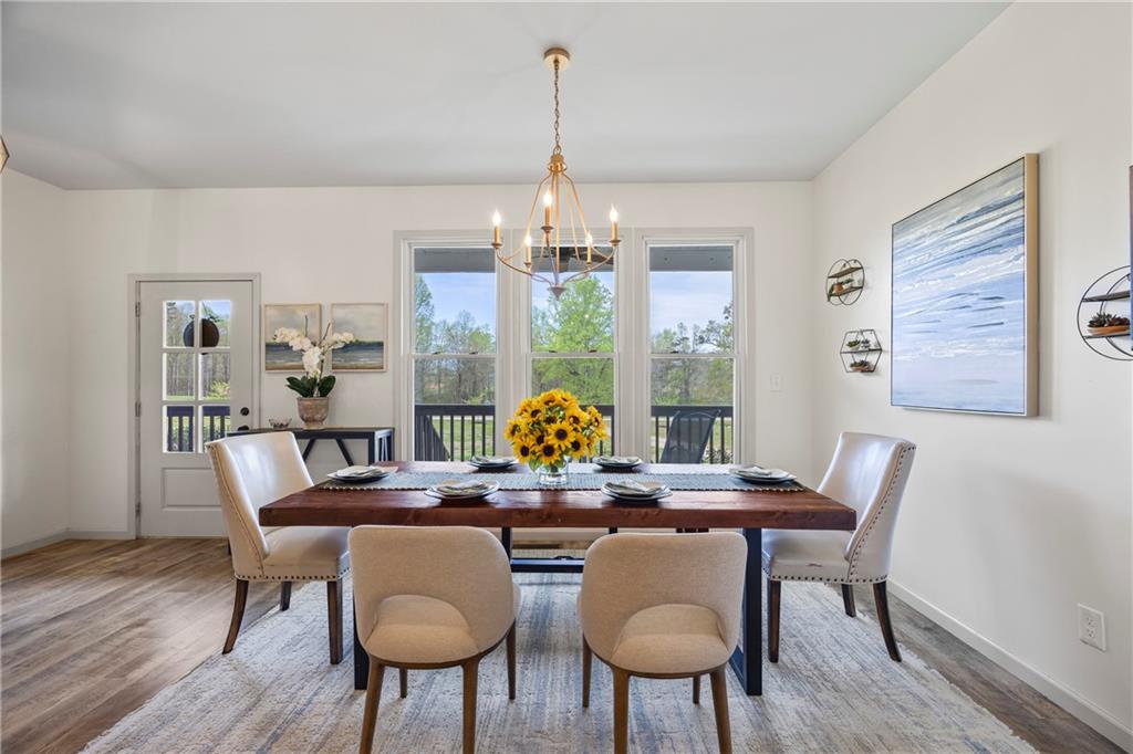 1308 Highway 82 Winder, GA 30680 - Photo 19 of 54 a view of a dining room with furniture wooden floor and chandelier