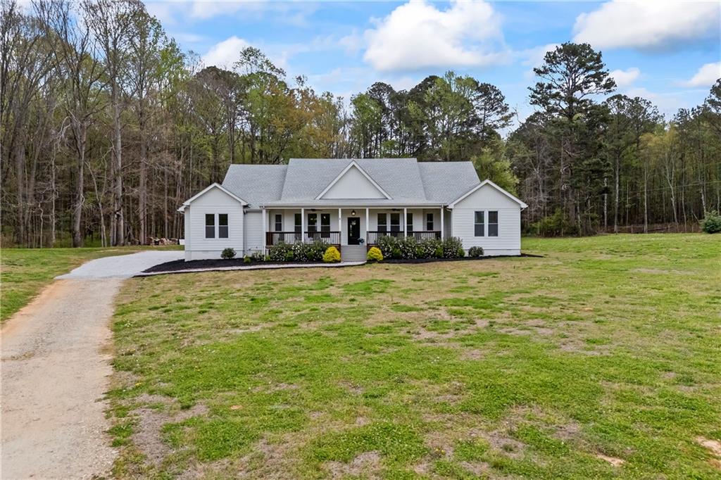 1308 Highway 82 Winder, GA 30680 - Photo 2 of 54 a front view of a house with swimming pool and trees in the background
