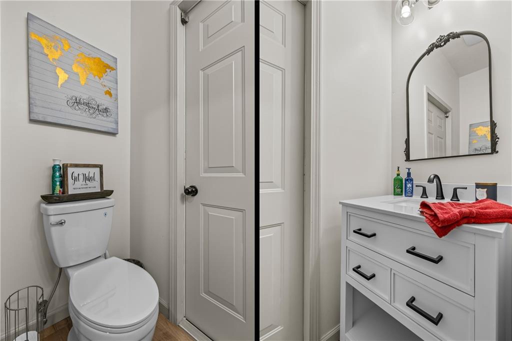 1308 Highway 82 Winder, GA 30680 - Photo 21 of 54 a bathroom with a toilet sink vanity and mirror