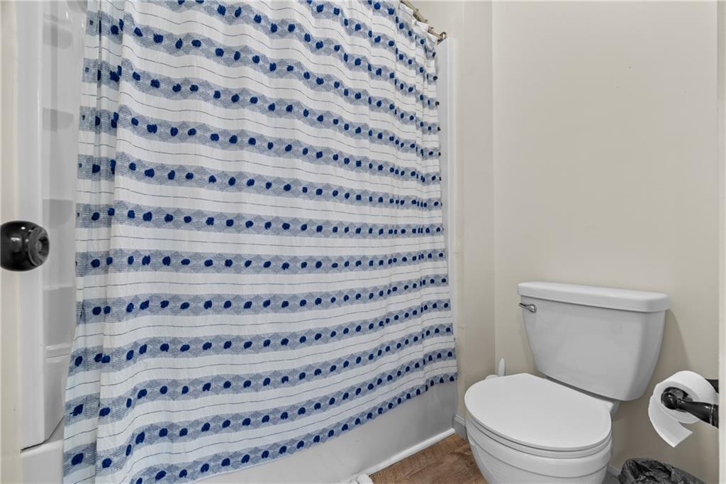 1308 Highway 82 Winder, GA 30680 - Photo 33 of 54 a bathroom with a toilet and a shower curtain