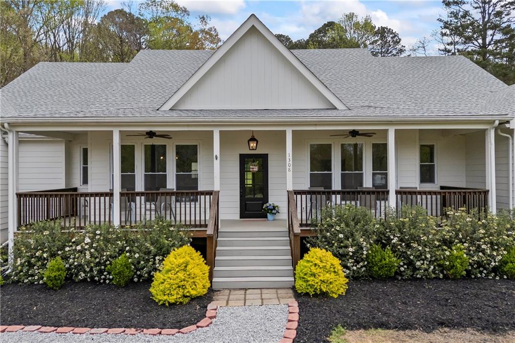 1308 Highway 82 Winder, GA 30680 - Photo 4 of 54 a view of brick house with potted plants and a flower garden