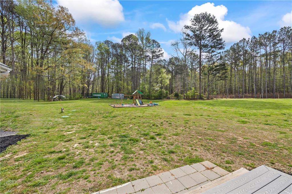 1308 Highway 82 Winder, GA 30680 - Photo 44 of 54 a swimming pool with trees in the background