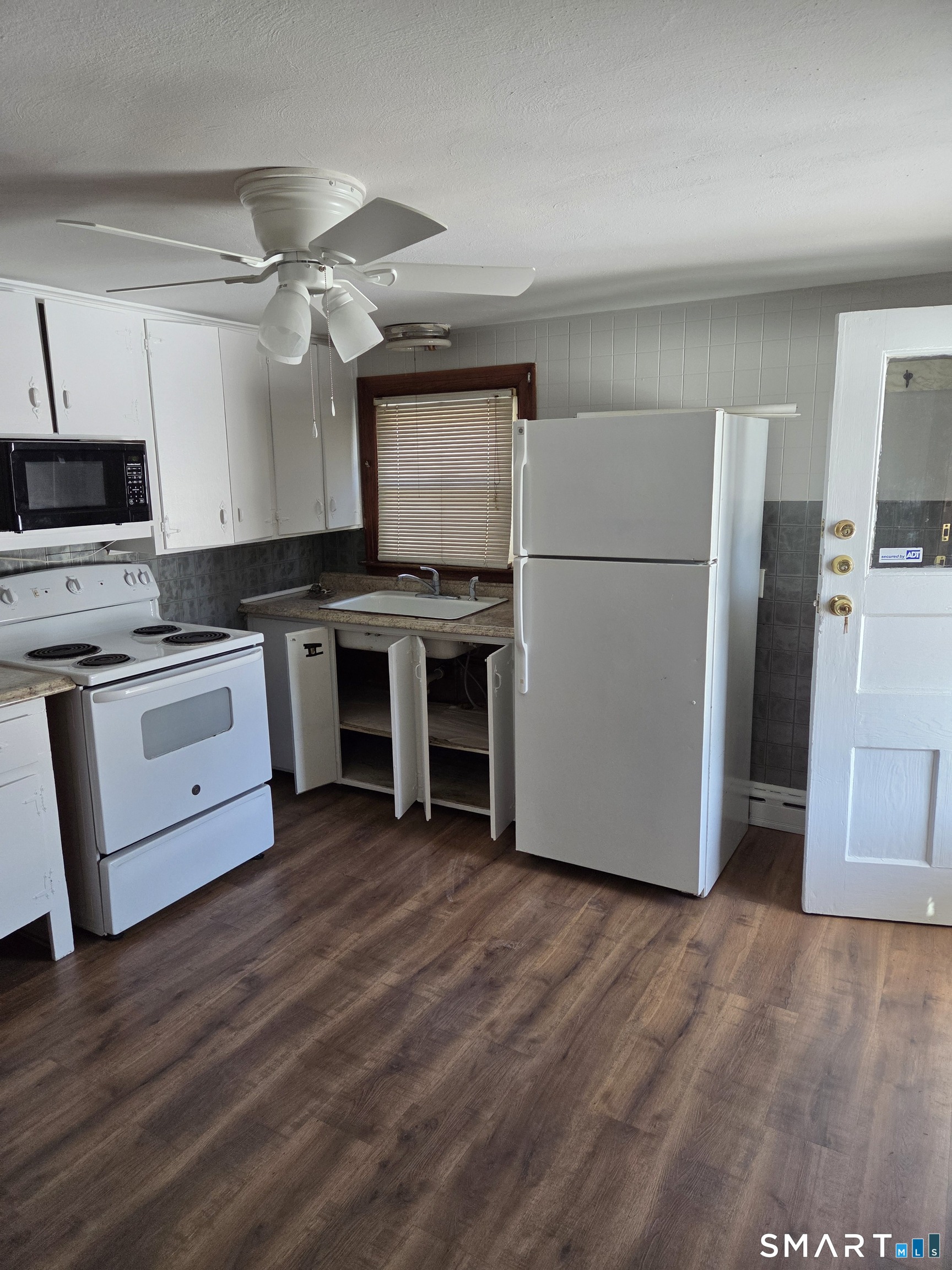 1372 New Haven Road Naugatuck, CT 06770 - Photo 7 of 11 a kitchen with stainless steel appliances a stove a refrigerator and a microwave