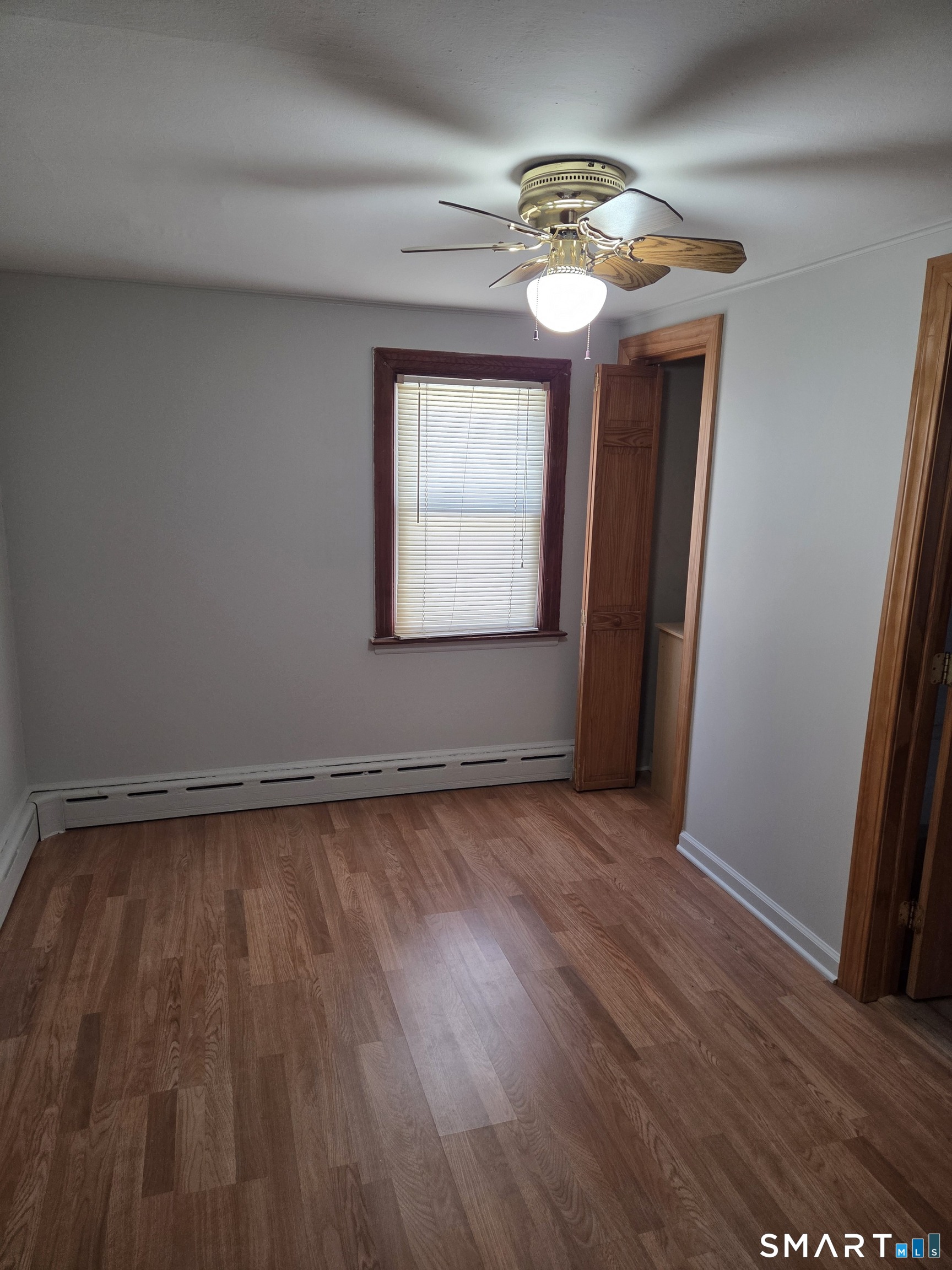 1372 New Haven Road Naugatuck, CT 06770 - Photo 9 of 11 an empty room with wooden floor and windows