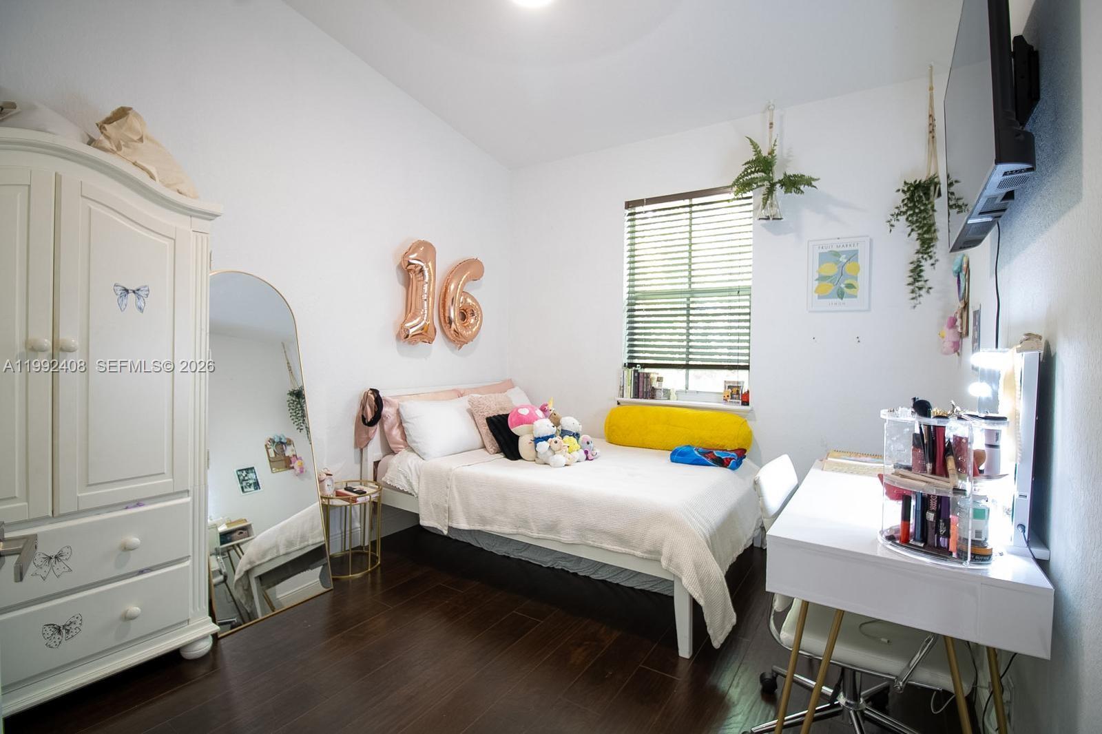 2607 Southwest 99th Way Miramar, FL 33025 - Photo 21 of 50 a bedroom with a bed and furniture