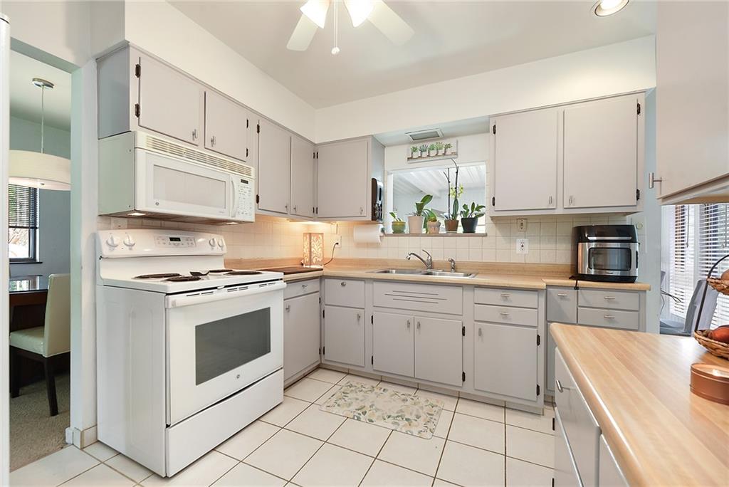 1323 Oakridge Road Bridgeville, PA 15017 - Photo 13 of 36 a kitchen with granite countertop white cabinets white stainless steel appliances a sink and a counter space