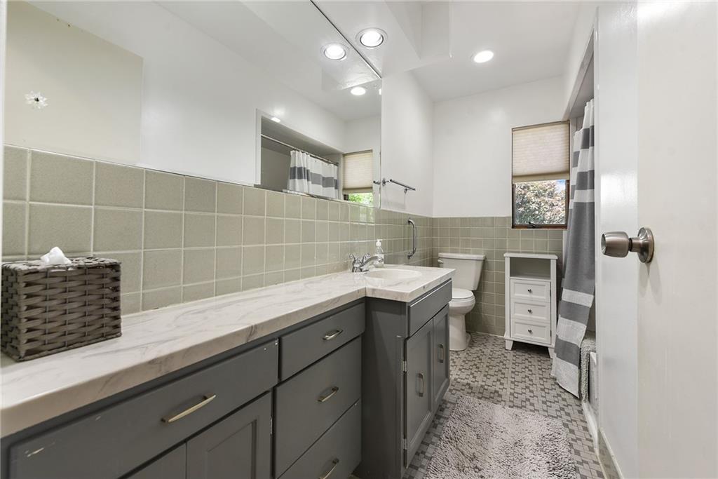 1323 Oakridge Road Bridgeville, PA 15017 - Photo 25 of 36 a spacious bathroom with a sink and mirror