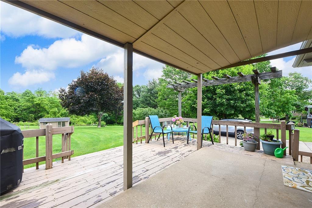 1323 Oakridge Road Bridgeville, PA 15017 - Photo 29 of 36 a view of a patio with table and chairs potted plants and a palm tree