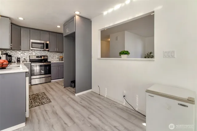 a kitchen with stainless steel appliances a refrigerator and a stove top oven