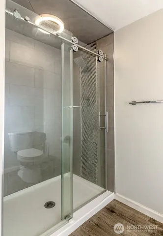a bathroom with a glass shower door