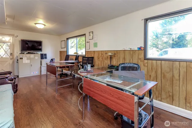 a living room with furniture a flat screen tv and a large window