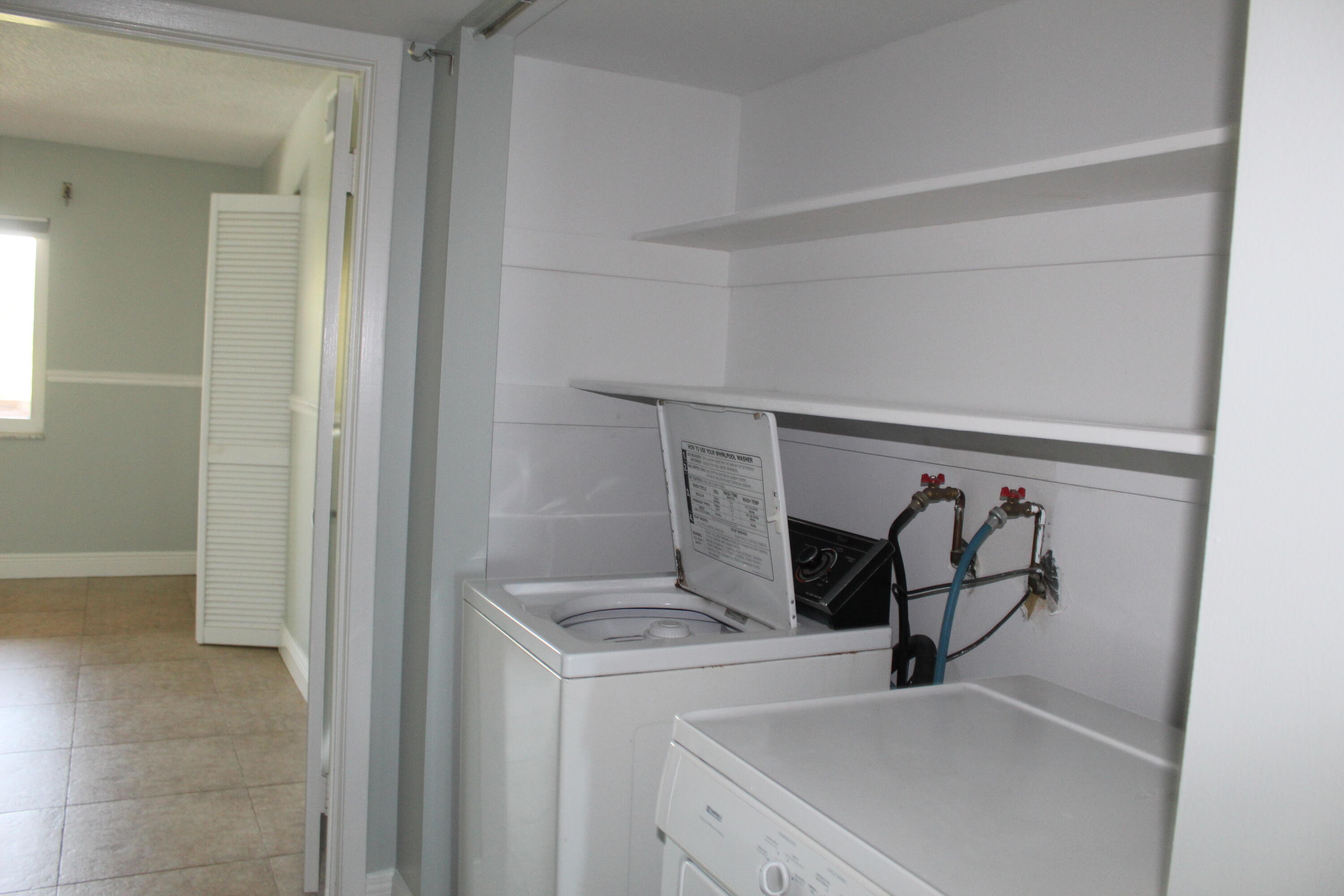 1617 Minutemen Causeway, Unit 202 Cocoa Beach, FL 32931 - Photo 16 of 20 a view of storage and utility room with washer and dryer