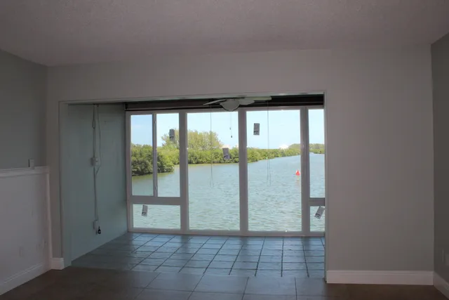 a view of empty room with floor to ceiling window