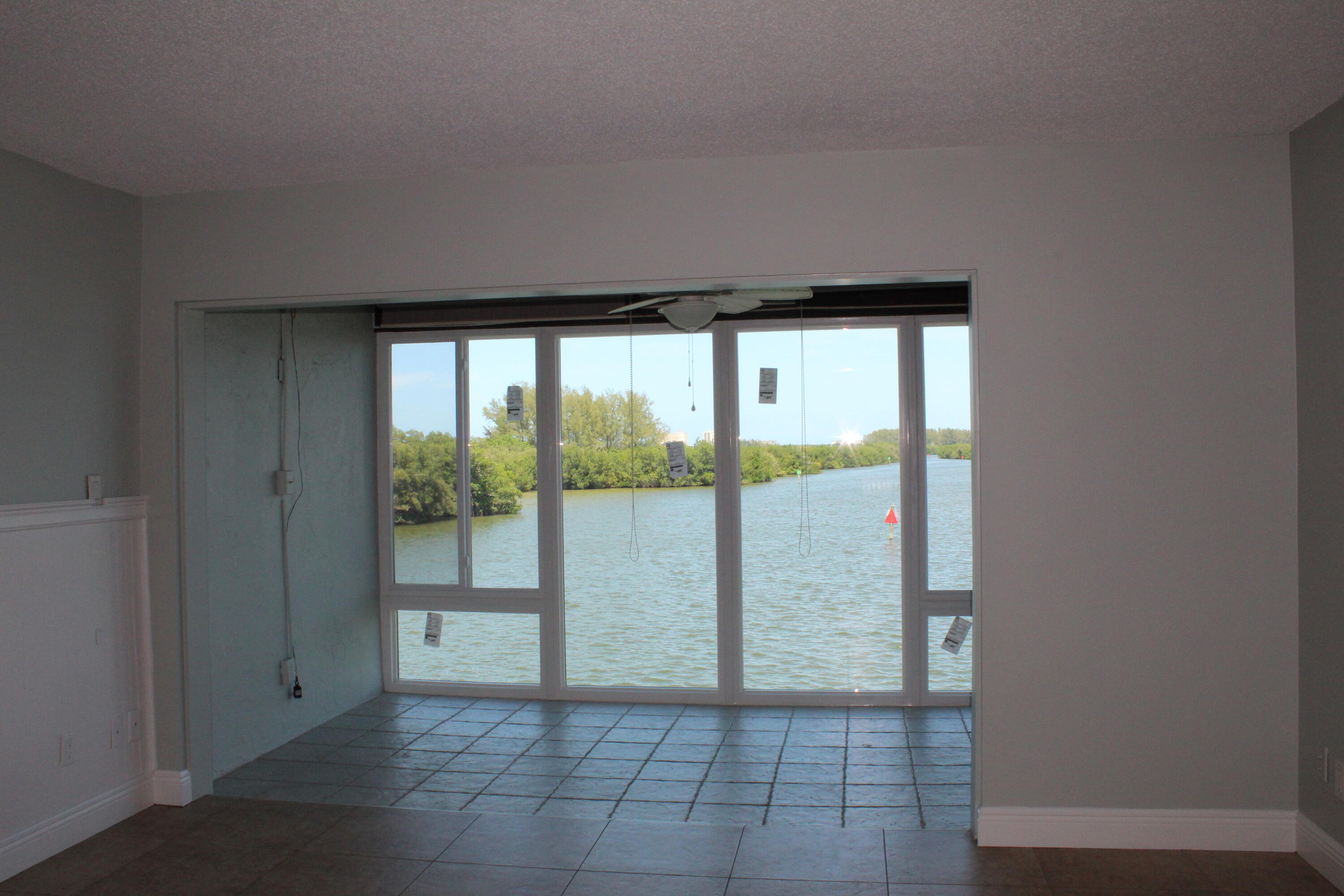 1617 Minutemen Causeway, Unit 202 Cocoa Beach, FL 32931 - Photo 2 of 20 a view of empty room with floor to ceiling window