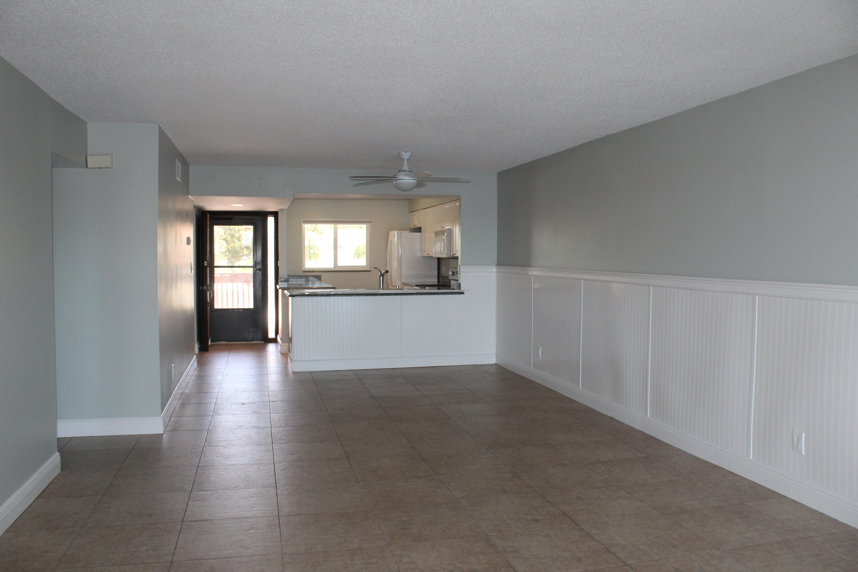 1617 Minutemen Causeway, Unit 202 Cocoa Beach, FL 32931 - Photo 4 of 20 an empty room with wooden floor and windows