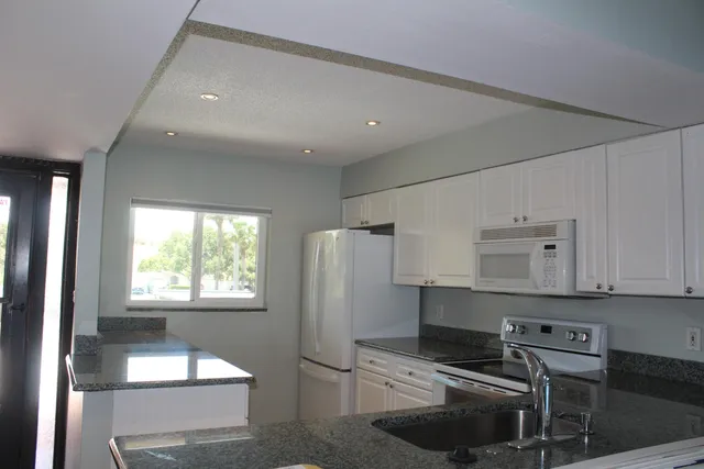 a kitchen with stainless steel appliances a stove a sink and a refrigerator
