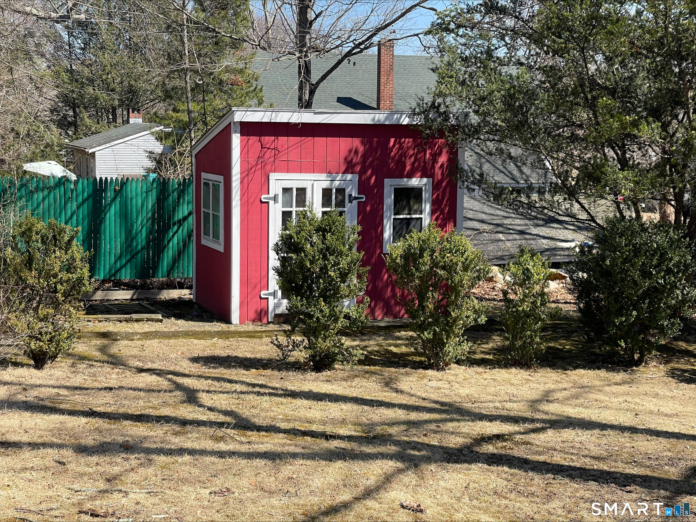 102 West Bridge Street Deep River, CT 06417 - Photo 7 of 35 a red brick house with flower garden and a tree