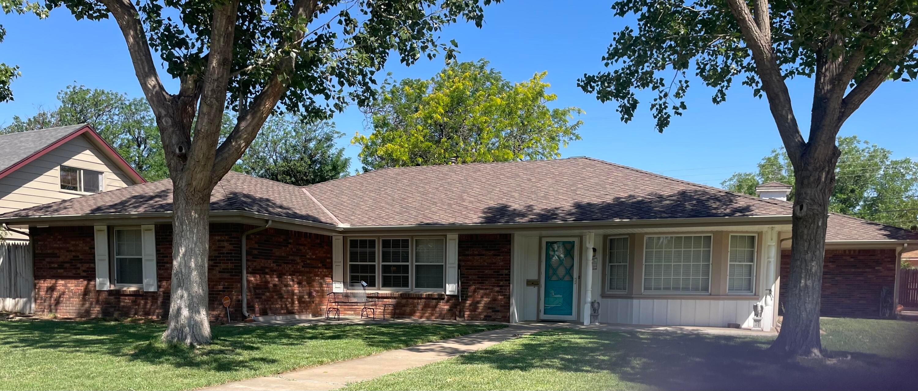 6200 Hanson Road Amarillo, TX 79106 - Photo 1 of 27 a front view of a house with a garden and porch