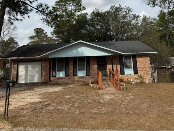 a front view of a house with a garden and porch