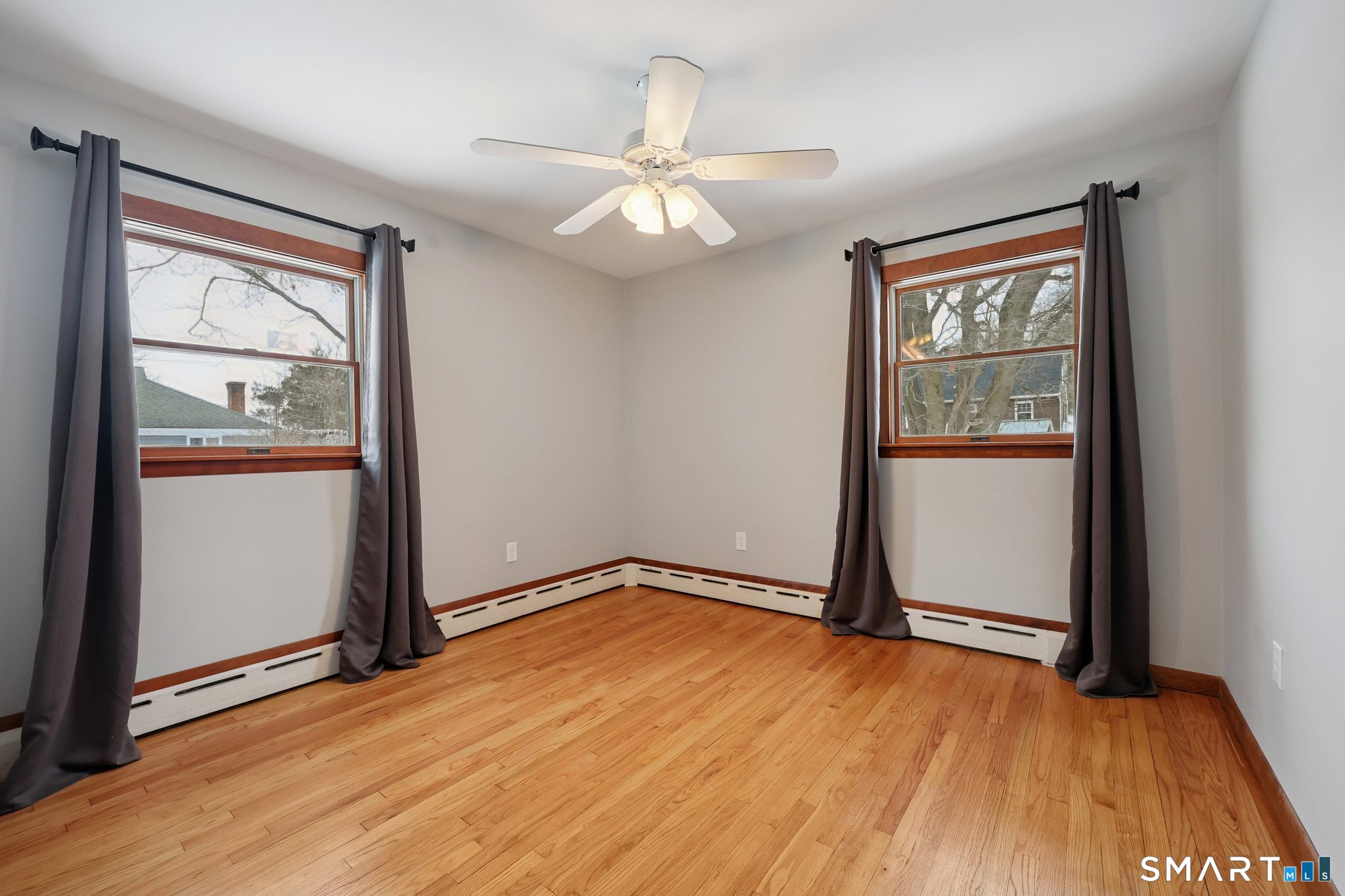 10 Hislop Street New London, CT 06320 - Photo 16 of 25 an empty room with wooden floor fan and windows