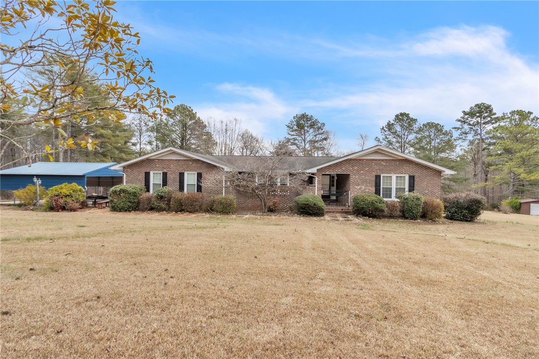 491 City Lake Road Pickens, SC 29671 - Photo 1 of 32 This classic brick residence features an expansive lawn and a functional covered carport.