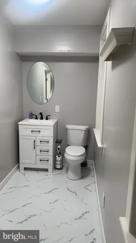 a white toilet sitting next to a bathroom sink