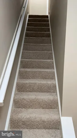 a view of a livingroom with wooden floor and a window