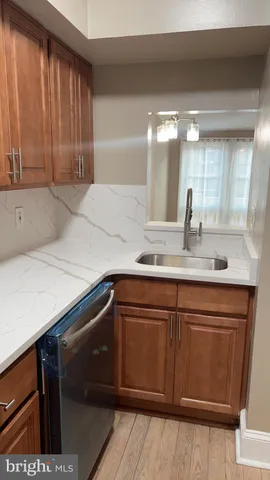 a view of a kitchen with a sink and a refrigerator