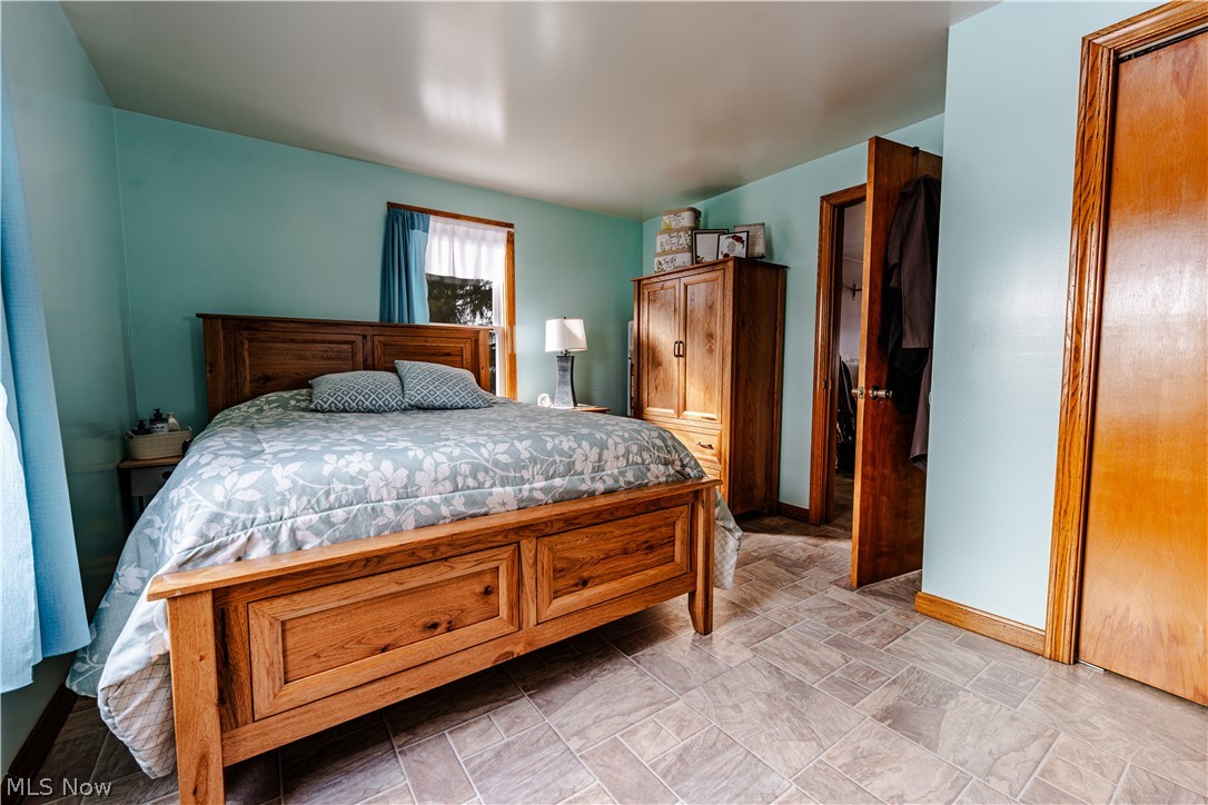 16350 Nauvoo Road Middlefield, OH 44062 - Photo 17 of 50 Bedroom with stone finish floors and baseboards