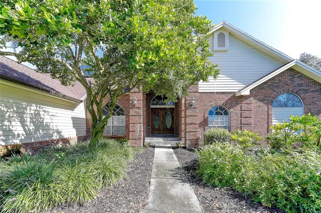 a view of a hallway with wooden floor and windows