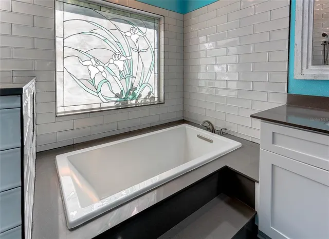 a view of a kitchen with sink and cabinets