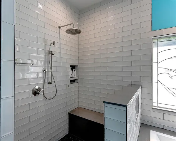 a kitchen with stainless steel appliances granite countertop a refrigerator a sink dishwasher a stove and white countertops with wooden floor