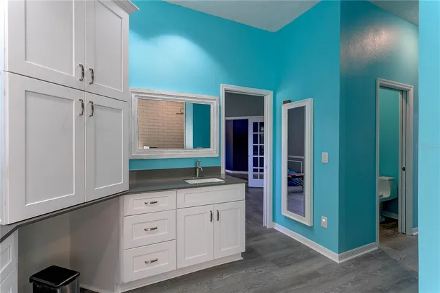 a kitchen with granite countertop a refrigerator and a stove top oven