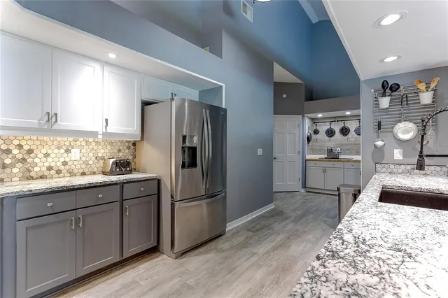 a kitchen with a refrigerator stove and microwave