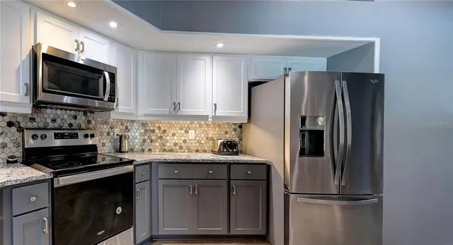 a view of a kitchen with a sink and cabinets