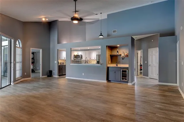 a living room with a fireplace a flat screen tv and a window