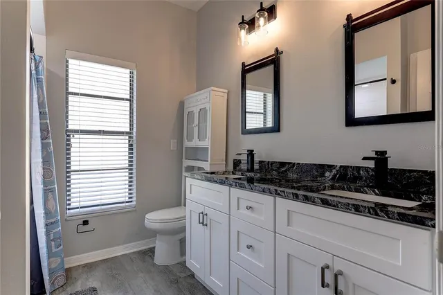 an empty room with a window and a ceiling fan