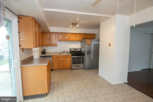 a kitchen with cabinets and refrigerator