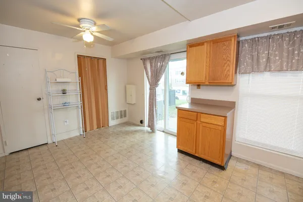 a view of a kitchen with a sink and a refrigerator