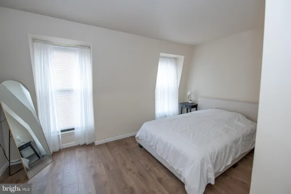 a bedroom with a bed and a desk in it