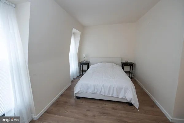 a bedroom with a bed and a chair