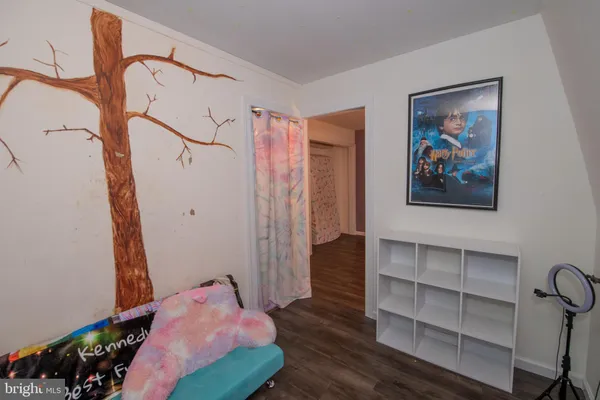 a view of a hallway with wooden floor and windows