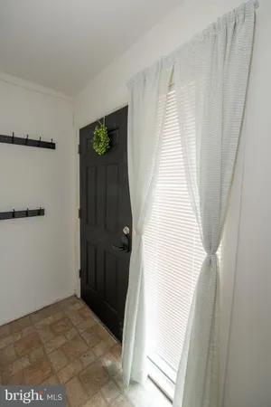 a view of a closet with wooden floor