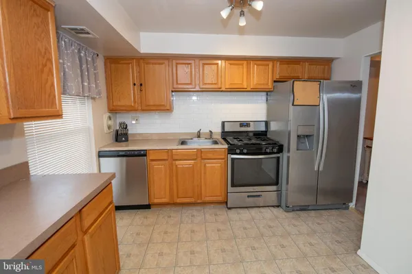 a kitchen with a sink a stove and refrigerator