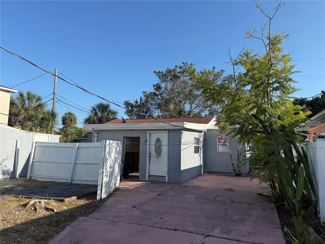 a view of a house with a yard and tree s