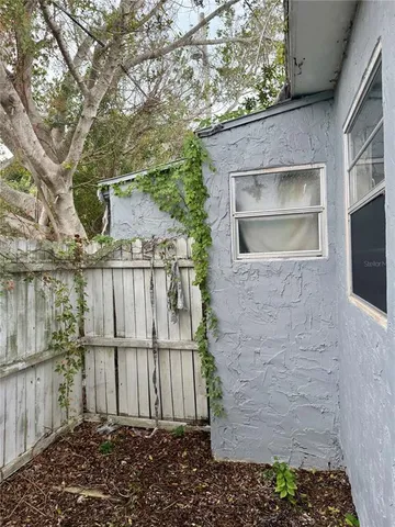a backyard of a house with a tree