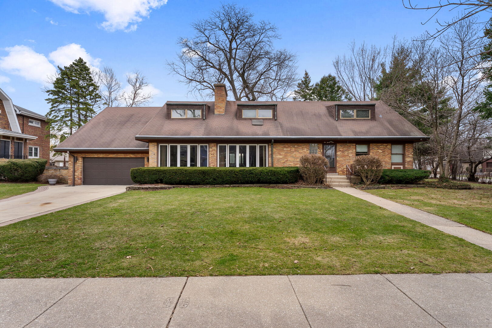 a front view of a house with a garden