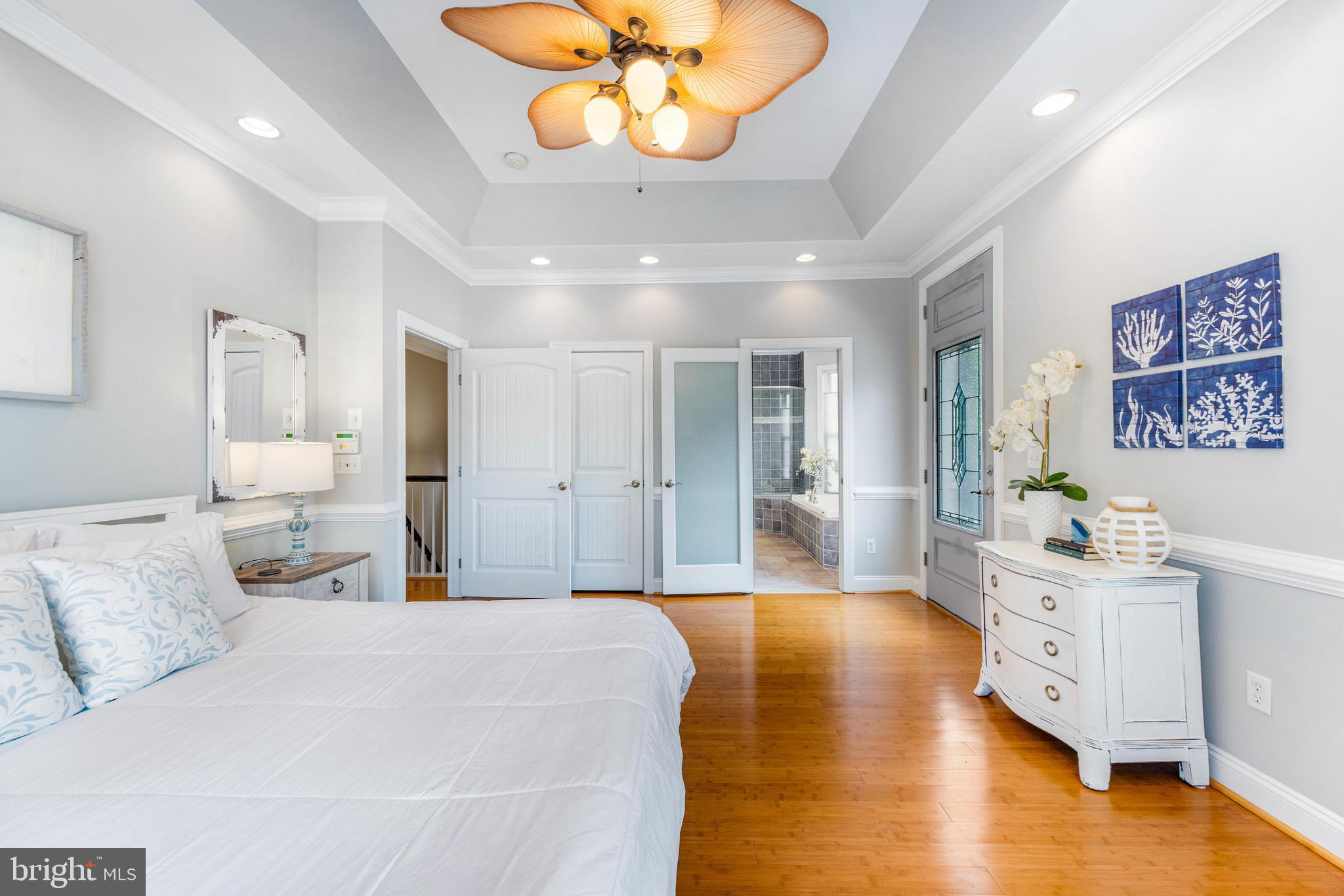 10 Dogwood Road Riva, MD 21140 - Photo 24 of 58 a spacious bedroom with a bed and a chandelier