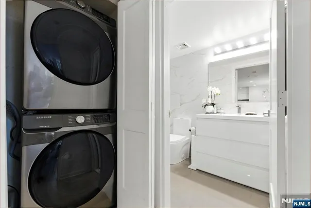 a utility room with sink dryer and washer
