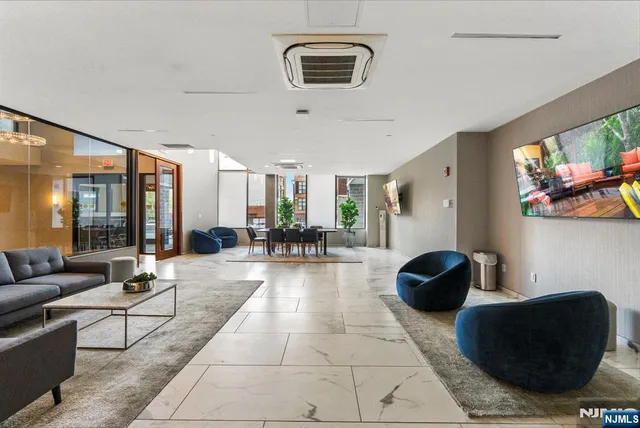 a living room with furniture and painting on the wall